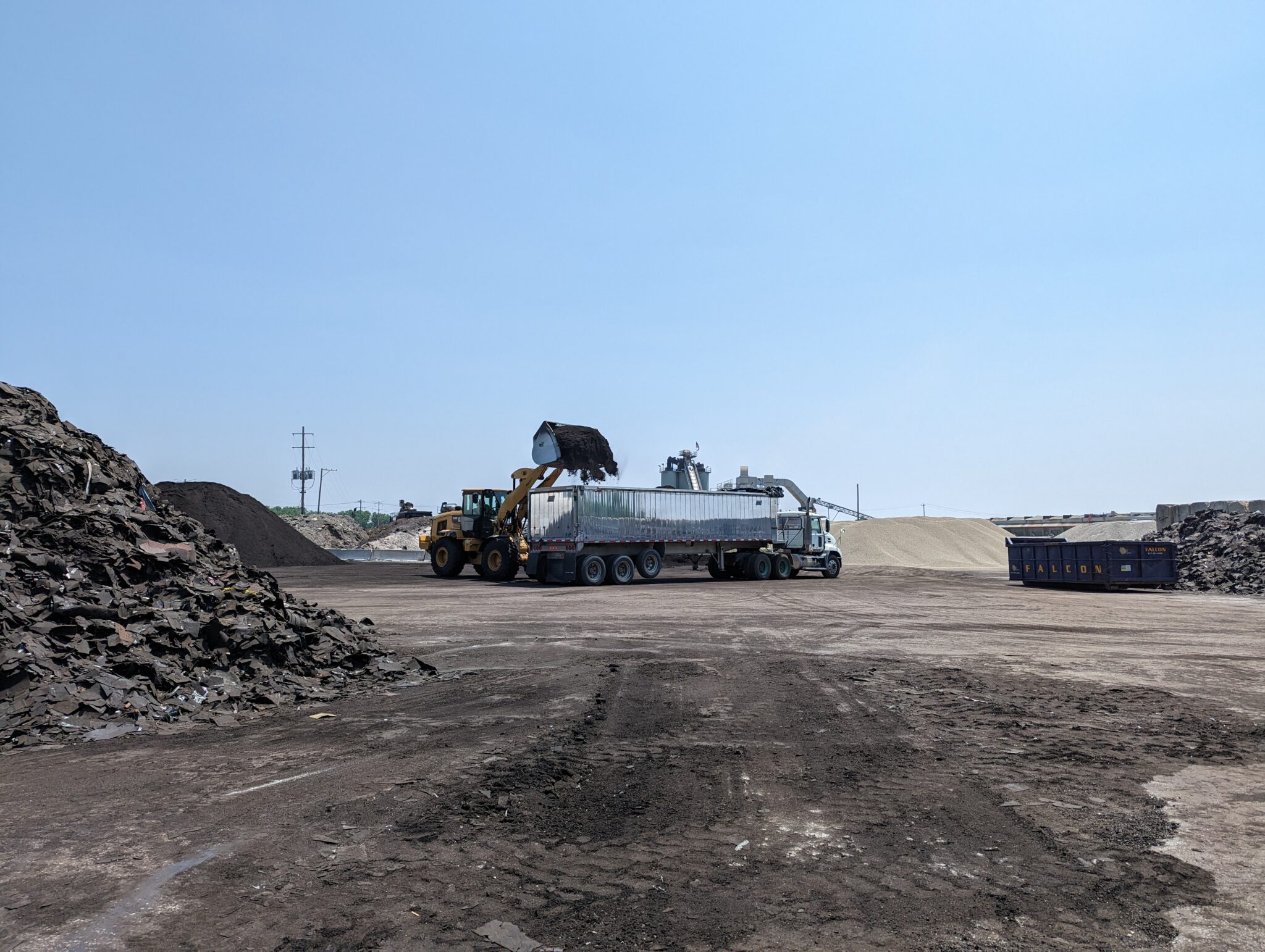 Loader and truck working incoming material at the Falcon Green Resources recycling yard