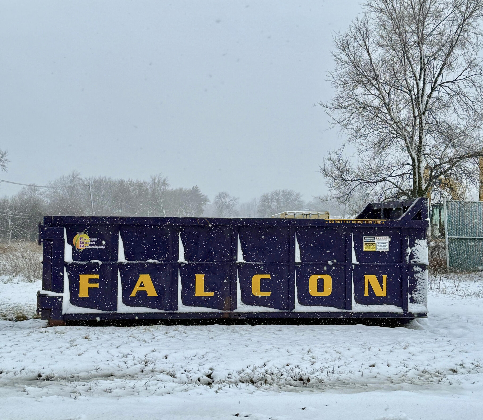 Falcon Green Resources roll-off dumpster on a job site